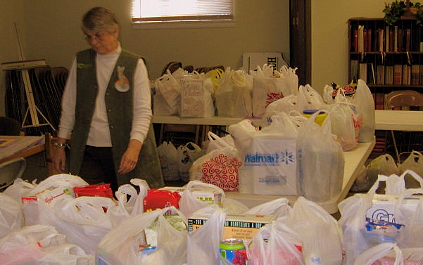 food pantry A food pantry volunteer surveys some of the groceries ready to be distributed. (photo by Tricia Hopkins)